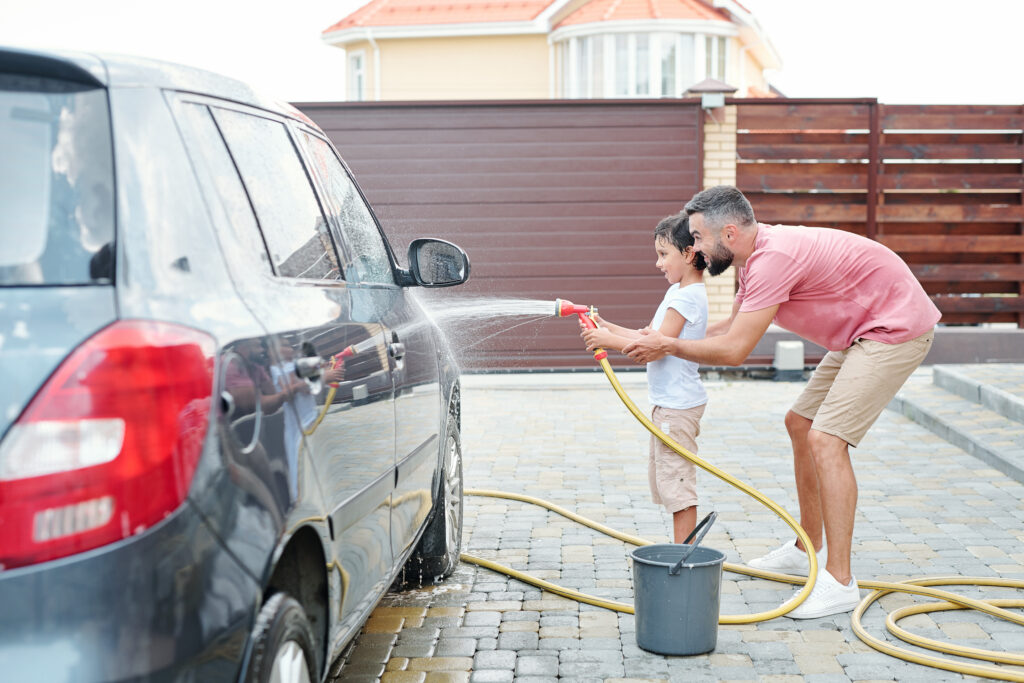 Father detailing his vehicle with premium car care products from Auto Barn in Essex Ontario